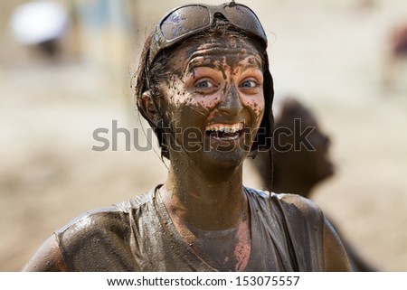 BOISE, IDAHO/USA - AUGUST 11:Unidentified woman gives the camera a huge grin at the The Dirty Dash in Boise, Idaho on August 11, 2013
