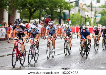 BOISE, IDAHO - JULY 14: Riders racing down the track in the rain the Boise Twilight Criterium in Boise, Idaho on July 14, 2012