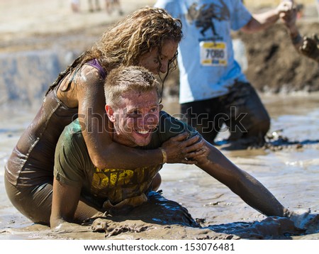 BOISE, IDAHO/USA - AUGUST 10: Unidentified couple horsing around in the mud pit near the finish at the The Dirty Dash in Boise, Idaho on August 10, 2013