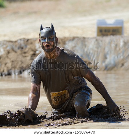 Boise, Idaho/Usa - August 10: Man 8272 Wearing A Batman Mask Splashes Mud At The Finish Line. This Race Took Place At The The Dirty Dash In Boise, Idaho On August 10, 2013