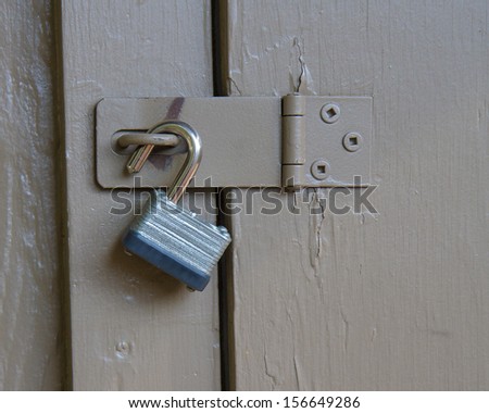 Lock up against a wooden door. Lock is held up currently and not very secure