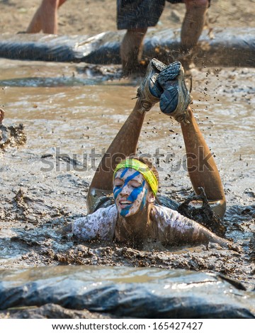 BOISE, IDAHO/USA - AUGUST 10: Unidentified woman fell into the mud pit at the The Dirty Dash in Boise, Idaho on August 10, 2013