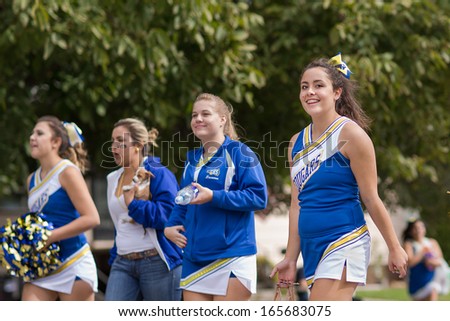 CALDWELL, IDAHO/USA - SEPTEMBER 27: One of the Caldwell High School Cheerleaders smile at the camera during the Caldwell High School Homecoming parade on September 27, 2013