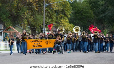 CALDWELL, IDAHO/USA - SEPTEMBER 27: A Group of students start the parade playing music and carry a banner at the Caldwell High School Homecoming parade on September 27, 2013