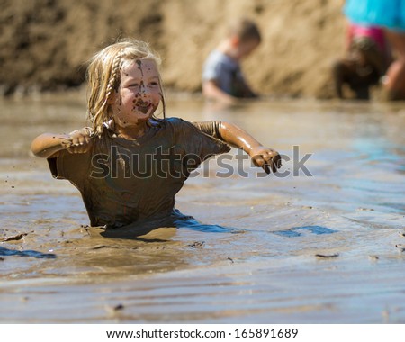 Boise, Idaho/Usa - August 10: Child Works Their Way Through The Pit Of Mud At The The Dirty Dash In Boise, Idaho On August 10, 2013