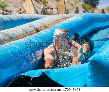 BOISE, IDAHO/USA - AUGUST 10, 2013: Unidentified man sees the end of the slide at the The Dirty Dash