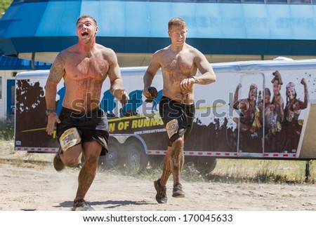 BOISE, IDAHO/USA - AUGUST 10, 2013: Two men run fast to finish the race at the The Dirty Dash