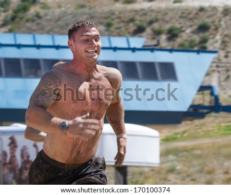 BOISE, IDAHO/USA - AUGUST 10, 2013: Unidentified man sprints at top speed during the The Dirty Dash