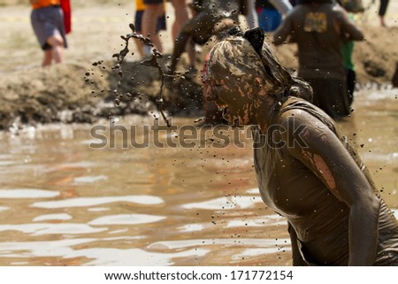 BOISE, IDAHO/USA - AUGUST 11, 2013: Unidentified woman gets a splash of mud thrown her way at the dirty dash