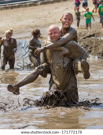 BOISE, IDAHO/USA - AUGUST 11, 2013: Unidentified man and woman work as a team at the dirty dash