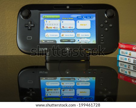 CALDWELL, IDAHO/USA - FEBRUARY 15, 2014: Wii U Game console standing up with Super Mario Bros U playing.