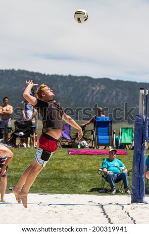 CASCADE, IDAHO/USA - JUNE 21, 2014: Unidentified man jumps to spike the ball at the Payette River Games