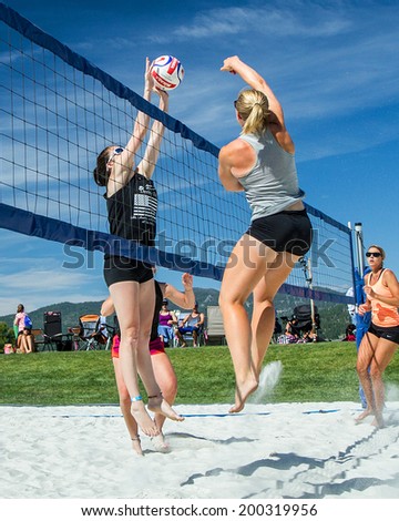 CASCADE, IDAHO/USA - JUNE 21, 2014: Two people jump at the net to make a play at the Payette River Games