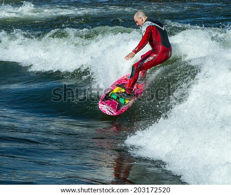 CASCADE, IDAHO/USA - JUNE 21, 2014: Surfer and his wave during the Payette River Games in Cascade, Idaho