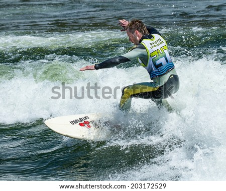 CASCADE, IDAHO/USA - JUNE 21, 2014: Surfer riding a wave during the Payette River Games at Cascade, Idaho