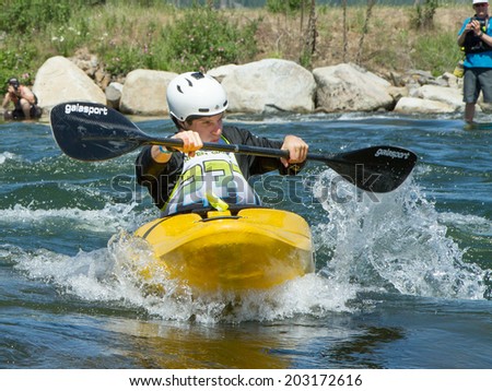 CASCADE, IDAHO/USA - JUNE 21, 2014: Kayaker 23 working his way through the river at the Payette River Games in Cascade, Idaho