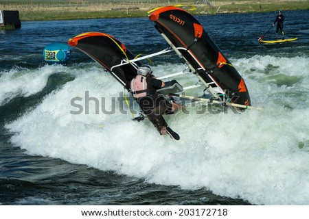 CASCADE, IDAHO/USA - JUNE 21, 2014: Rafter at the Payette River Games gets stuck in a wave and topples over.