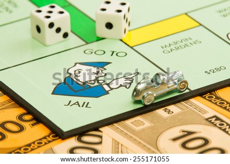 BOISE, IDAHO - NOVEMBER 18, 2012:  The car piece is speeding away from the go to jail spot on the famous Hasbro game Monopoly.