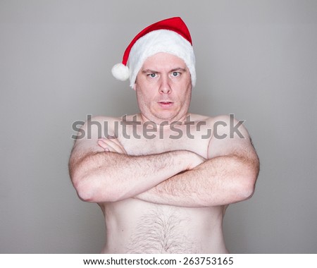 Big man being topless with a santa hat on