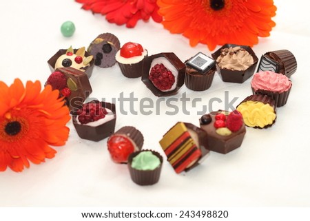 Valentine\'s day. Chocolates in the form of heart and flowers.