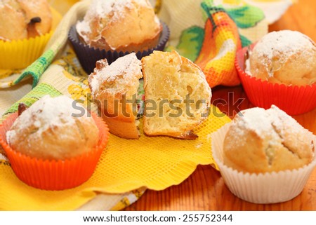 muffins roll cakes in multi-colored paper wrappers on a towel