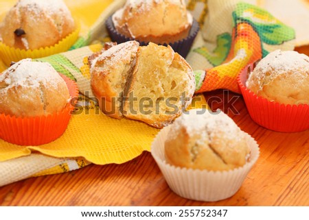 muffins roll cakes in multi-colored paper wrappers on a towel