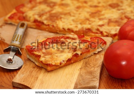 piece of pizza Margarita on a wooden chopping board