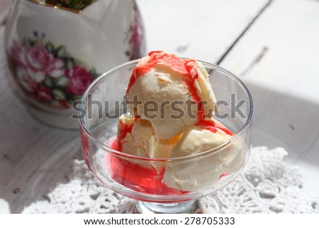 coconut ice cream with syrup in glass ice-cream bowls