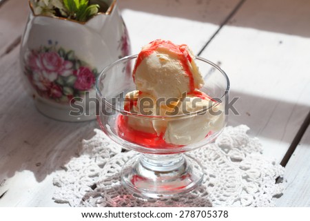 coconut ice cream with syrup in glass ice-cream bowls