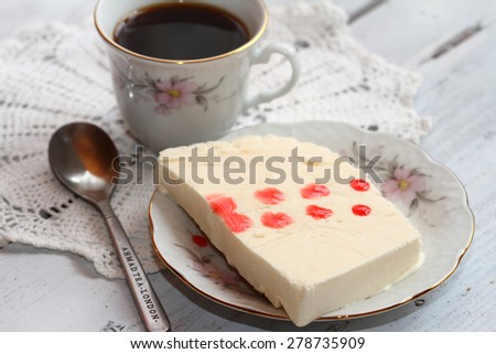 coconut ice cream with syrup and a cup of coffee on a white background