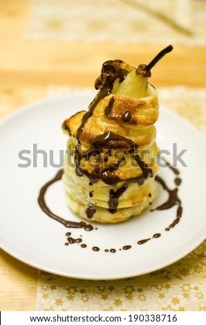 Delicious food baked pear in pastry crust cooked in wine with chocolate topping. Christmas traditional dessert