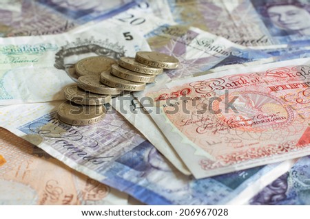 Pile of money and stacked coins british pounds sterling gbp for business and finance