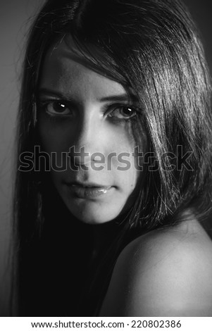 Fashion portrait of a very beautiful young woman. Black and white image of sexy model with perfect skin and eyes for cover