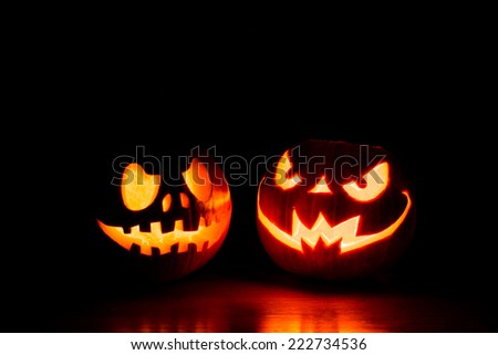 Scary Halloween pumpkins isolated on a black background. Scary glowing faces trick or treat