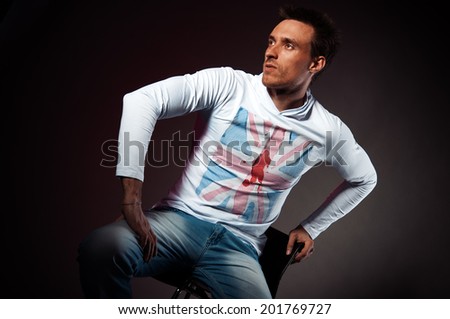 Sporty English man on the black background