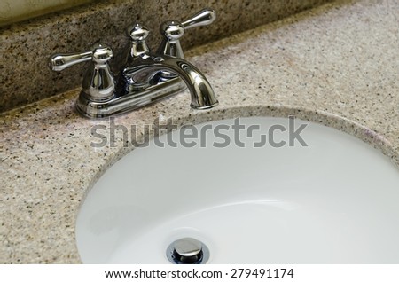 Retro style Chrome Faucet and old sink in bathroom. Selective focus on a tap