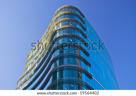 cool blue office building against sky