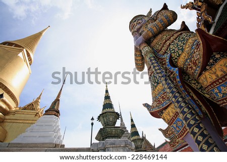 BANGKOK - THAILAND -  1 NOVEMBER 2014 : Demon Guardian with Landscape and Pagodas in Wat Phra Kaew (the temple in grand palace) on Bangkok, Thailand