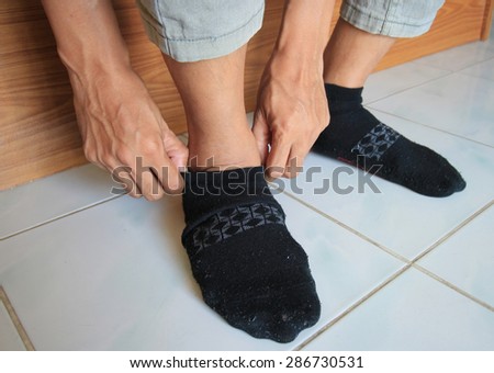 Close up of a man wearing black sock