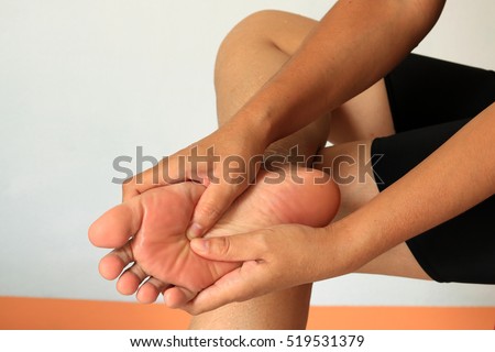 woman checks her aching foot
