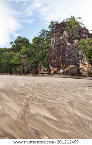 Big cliff lush jungle and sand