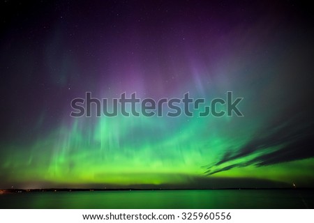 Beautiful northern lights aurora borealis over lake in finland