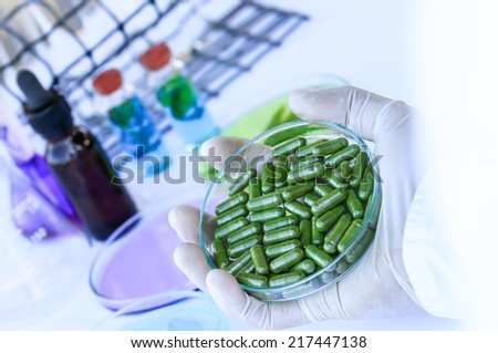 The researcher is synthesizing medicine in laboratory room.