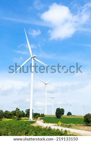 green meadow with wind turbines generating electricity