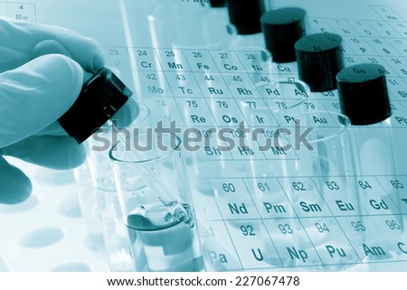 A researcher dropping clear solution into test tube at laboratory.