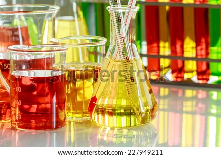 Chemists are measuring the temperature of the solution in a test tube in a laboratory