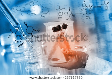 Gloved hand hold a beaker, with chemical equations background, in laboratory room