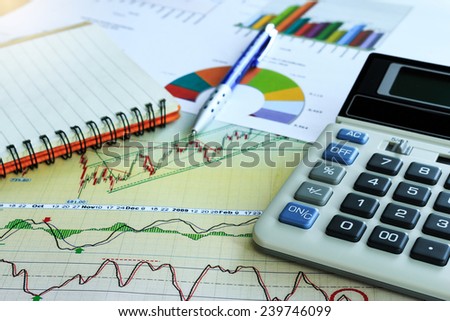 Chart report with blue pen and calculator for the business concept