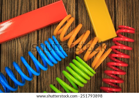 metal, car spring parts coated with powder coating on wooden background.