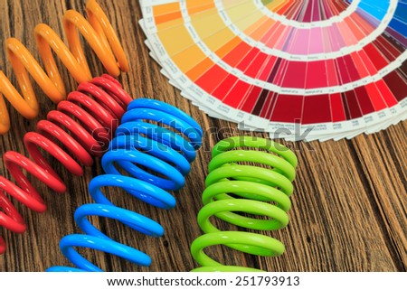 metal, car spring parts coated with powder coating and color chart on wooden background